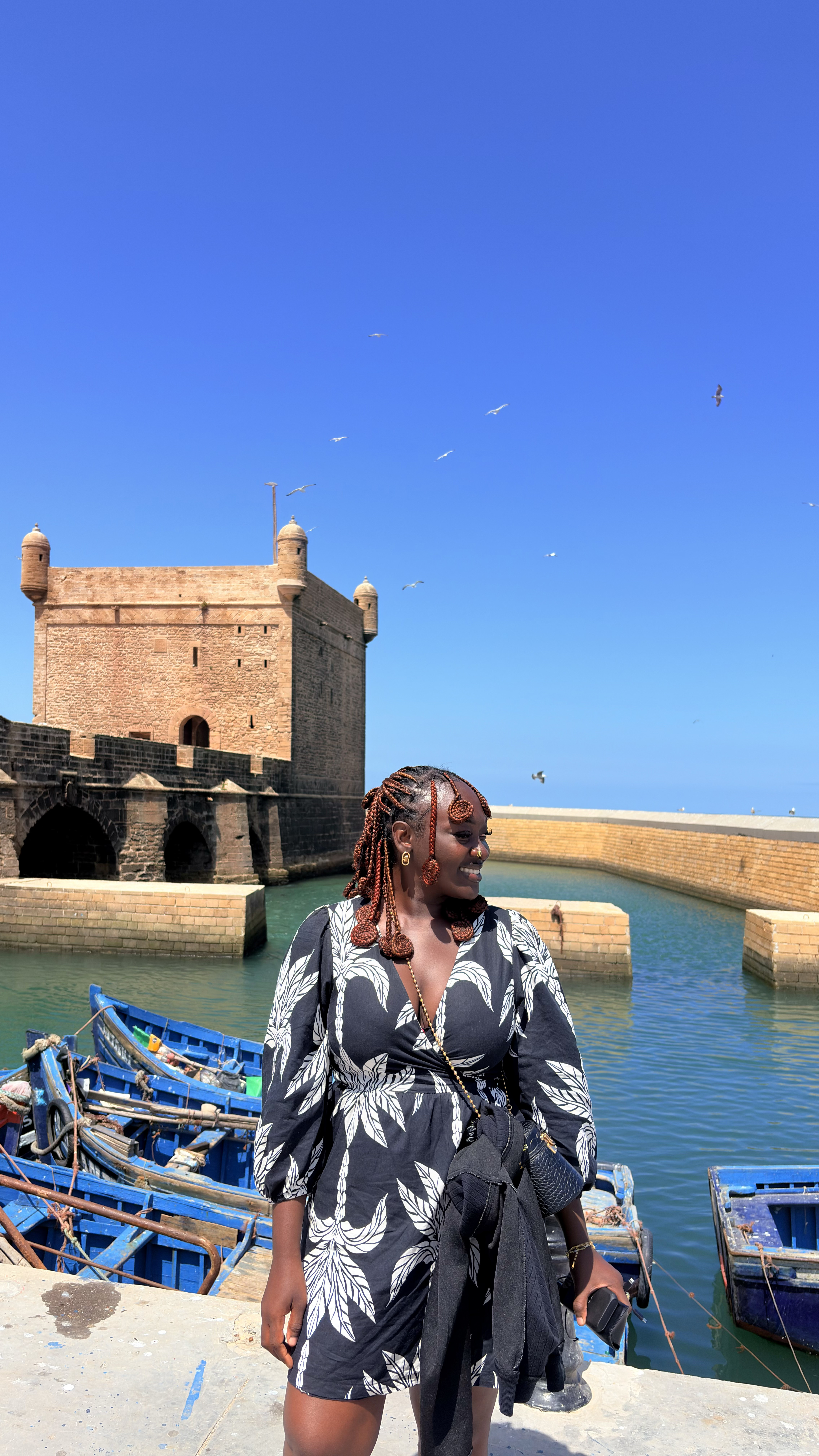 Founder overlooking a harbour with blue fishing boats