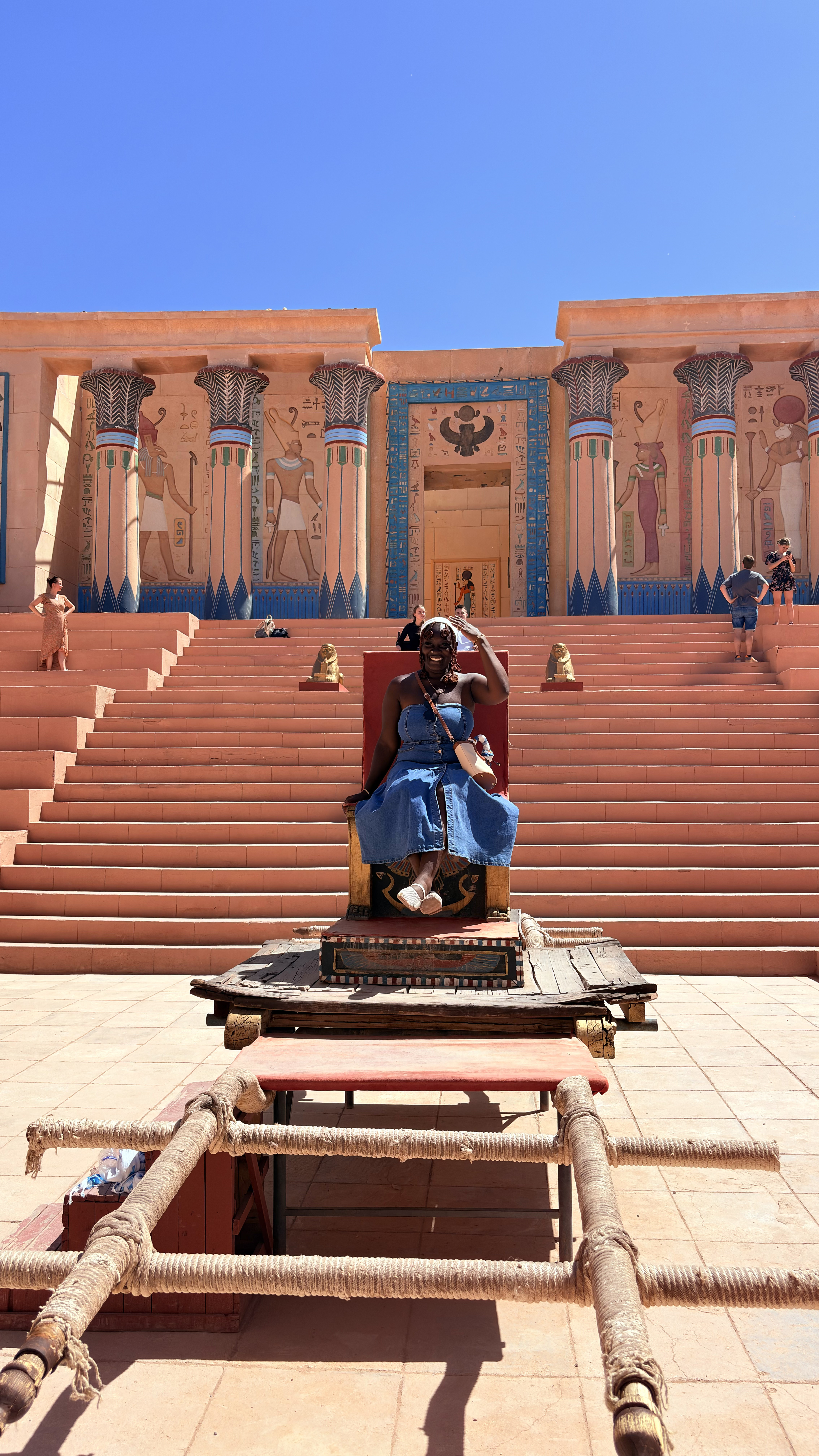 Founder seated on ceremonial steps during her travels